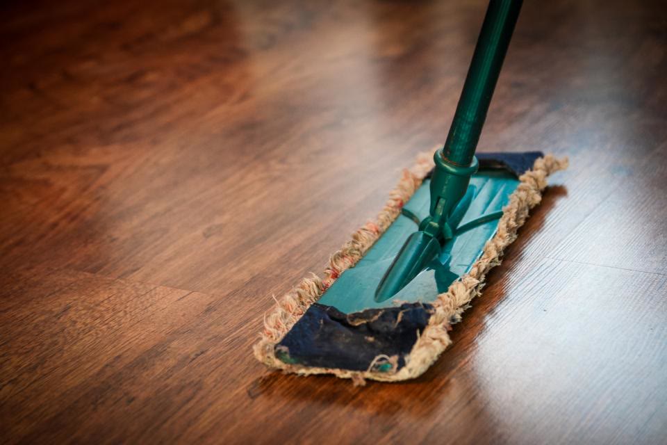Mop cleaning a polished timber floor