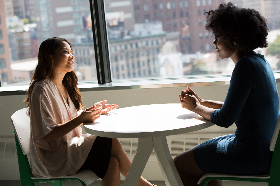 Candidate and recruiter talking at a table